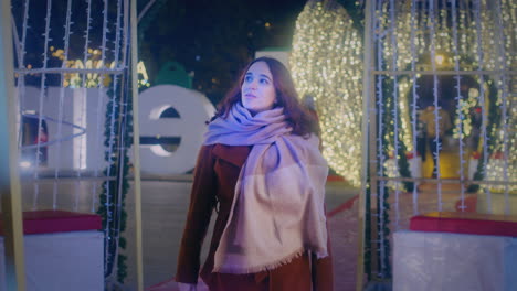 girl-walks-and-enjoys-the-Christmas-lights-slow-motion-wide-shot