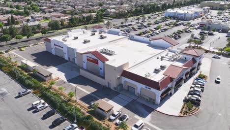 hyper-lapse-of-a-large-industrial-strip-mall-center-in-california-day-time-bright-sun-AERIAL-ORBIT