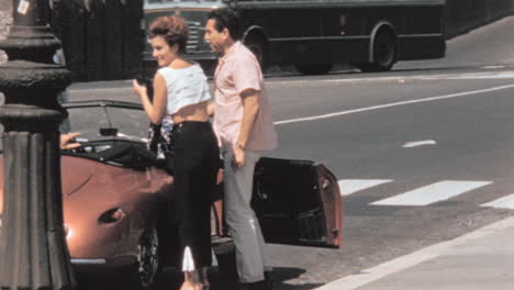 Woman-and-Man-Get-into-a-Classic-Car-on-Rome-Street-in-the-1960s