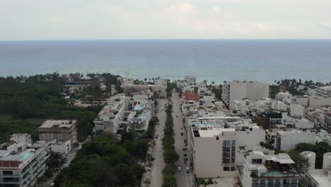 An-aerial-shot-pushing-into-the-coastline-from-the-city-of-Playa-del-Carmen-in-Mexico-on-an-overcast-day
