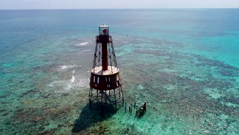 An-4K-drone-shot-of-an-abandoned-lighthouse,-in-a-remote-area-of-the-Caribbean-Sea,-near-Bimini,-Bahamas