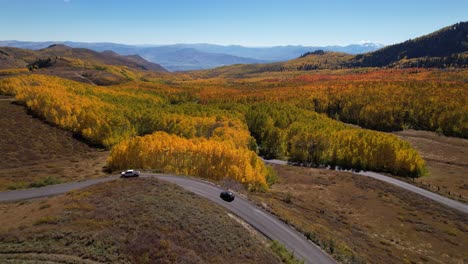Weitreichende-Luftaufnahme,-Die-Einer-Straße-Entlang-Der-Gelben-Espenbaumwipfel-In-Utah-Folgt