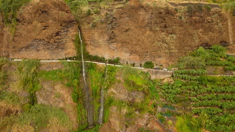 Spectacular-high-Waterfall-with-Water-falling-on-asphalt-Road