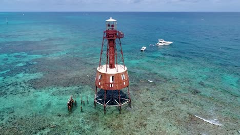 An-4K-drone-shot-of-an-abandoned-lighthouse,-in-a-remote-area-of-the-Caribbean-sea,-near-Bimini,-Bahamas