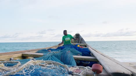 black-male-fisherman-preparing-the-net-for-fishing-in-tropical-ocean-sea