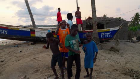 group-of-native-black-african-young-kids-dancing-together-in-front-of-the-camera-in-remote-fisherman-village-in-africa