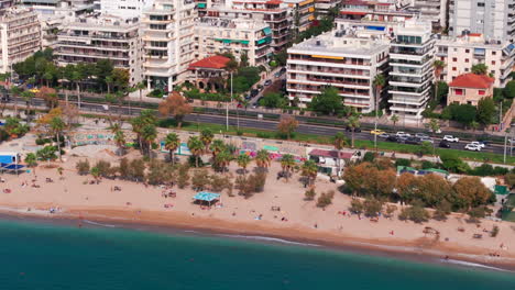 Pan-up-reveal-aerial-shot-of-Athens-sea-front-promenade