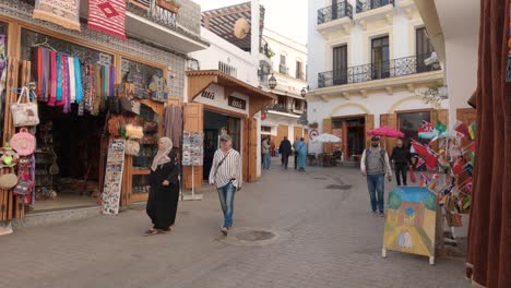 In-Der-Medina-Von-Tanger,-Marokko,-Kommen-Menschen-An-Traditionellen-Lokalen-Produkten-Und-Kunsthandwerk-Vorbei