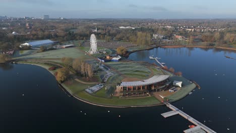 An-aerial,-early-morning-view-of-Willen-Lake-in-Milton-Keynes,-showing-the-waterfront-and-Observation-Wheel