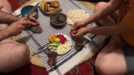local-food-breakfast-table-cloth-turkish-kahvalti-with-olive-black-tea-persian-bread-simple-meal-at-home-in-rural-town-authentic-food-couple-life-in-Iran-young-family-sexy-relationship-Persian-culture
