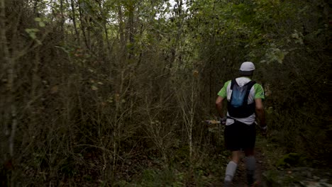 Templars-Trail-Runner-in-Dense-Millau-Woods,-France---Tracking-shot