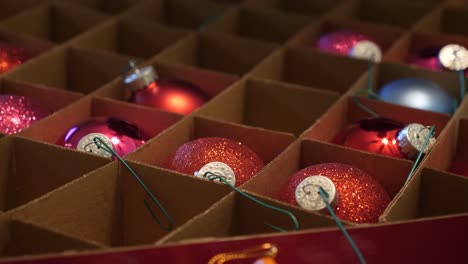 Close-Up-of-a-Person-Selecting-Pretty-Ornaments-to-Place-on-the-Christmas-Tree