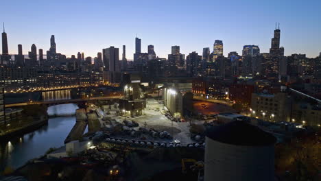 Heavy-machinery-working-at-the-Ozinga-Concrete,-dusk-in-Chicago---Aerial-view