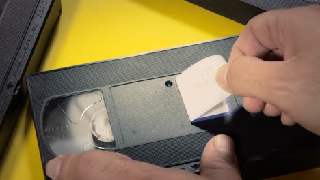 Ich-Schreibe-Den-Text-„Play-Me“-Mit-Einem-Marker-Auf-Das-Weiße-Etikett-Einer-Alten-VHS-Videokassette