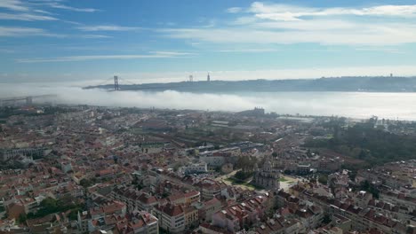 A-bird's-eye-view-of-Lisbon,-Portugal,-with-the-iconic-Ponte-25-de-Abril-and-Cristo-Rei-in-the-background