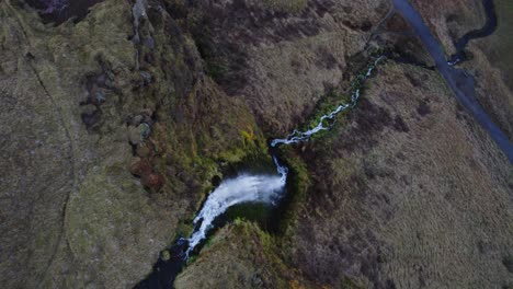 Dynamic-drone-establisher-famous-waterfall-Seljalandsfoss-in-Iceland-steep-rock