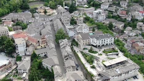 Drone-view-in-Albania-flying-in-Gjirokaster-over-a-medieval-town-showing-the-brick-brown-roof-houses