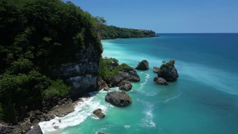 Rocky-cliffs-and-vibrant-blue-water-on-the-south-coast-of-Bali,-Indonesia