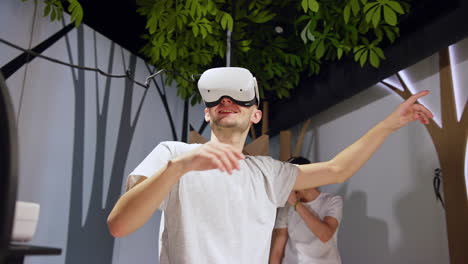 Boys-having-fun-in-the-museum-VR-room,-using-virtual-reality-headsets,-low-angle