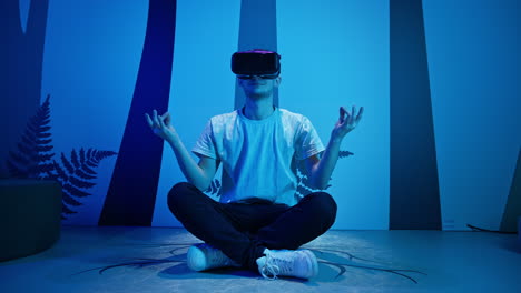 Man-with-VR-glasses-sitting-on-the-virtual-reality-escape-room-floor,-handheld