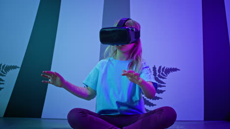 Girl-child-in-VR-glasses-having-interaction-with-virtual-reality,-low-angle-shot
