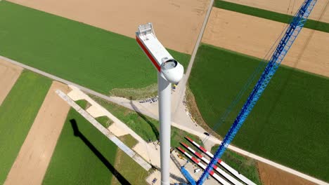 The-Head-of-a-Wind-Turbine-Being-Assembled---Drone-Orbit-Shot