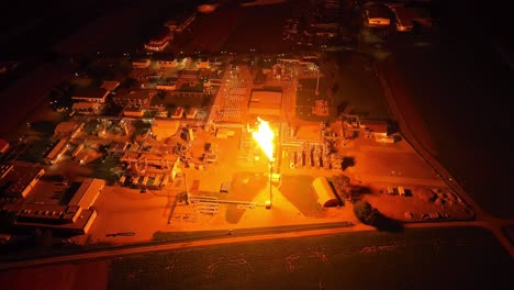 The-Entire-Facility-is-Bathed-in-Light-as-Gas-Flaring-Occurs---Drone-Orbit-Shot