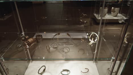 ancient-jewelry-in-glass-case-at-the-exhibition-in-the-museum-of-Biskupin,-Poland