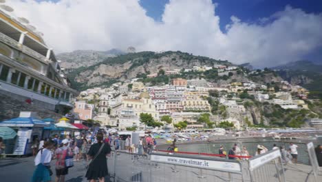 Amalfi-Positano-Italy-Immersive-Travel-Tourism-Mediterranean-Sea-Coast-Water-Europe,-Walking,-4K-|-Large-Crowd-on-Boat-Dock-and-Beach-Near-To-Breathtaking-Mountainside