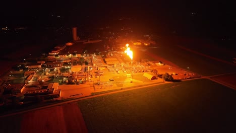 Observing-Gas-Flaring-Casting-its-Light-Across-the-Plant---Pan-Up-Shot