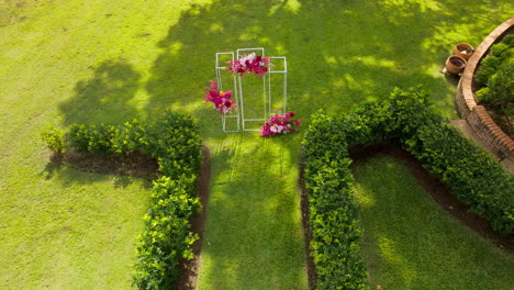 Beautiful-Green-Garden-Wedding-Ceremony-Setup-With-Decorated-Arbour,-4K-Drone