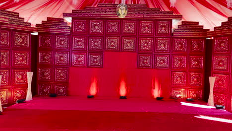 Pan-right-shot-of-stage-richly-decorated-in-red-for-performance-of-Indian-play