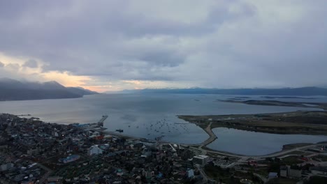 Drone-shot-flying-over-Ushuaia,-Argentina-towards-the-Beagle-Channel-at-sunset