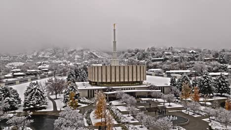 Drone-trucking-pan-highlights-snow-covered-grounds-of-Provo-LDS-Mormon-Temple