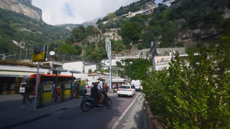 Amalfi-Positano-Italy-Immersive-Travel-Tourism-Mediterranean-Sea-Coast-Water-Europe,-Walking,-4K-|-Motorcycle-Driving-in-Traffic-Exploring-Roads-Below-Famous-Mountainside-Cliffs,-Shaky