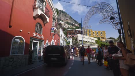 Amalfi-Positano-Italy-Immersive-Travel-Tourism-Mediterranean-Sea-Coast-Water-Europe,-Walking,-4K-|-Muscle-Man-Walking-Past-Exploring-Roads-Below-Famous-Mountainside-Cliffs,-Shaky,-Anxiety-Inducing