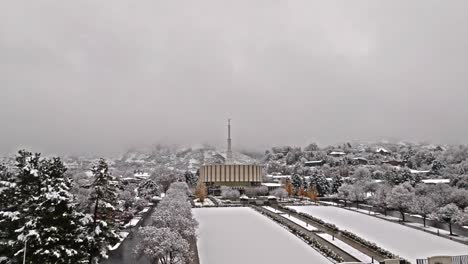Drone-flies-over-snow-covered-trees-to-reveal-Provo-LDS-Mormon-Temple-in-winter
