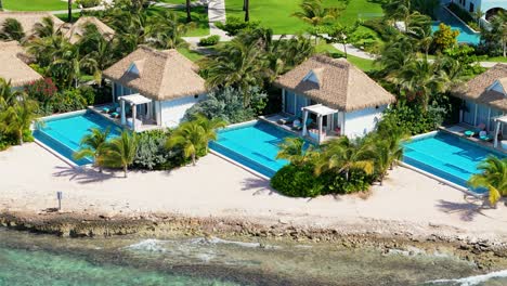 Drone-telephoto-view-of-hotel-villas-with-private-infinity-pools-looking-out-on-clear-Caribbean-water,-Curacao