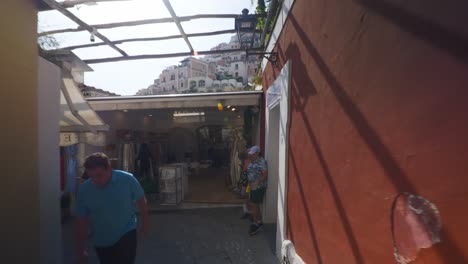 Amalfi-Positano-Italy-Immersive-Travel-Tourism-Mediterranean-Sea-Coast-Water-Europe,-Walking,-4K-|-Scenic-Mountainside-Homes-Overhead-From-Crowded-Ally-in-Shadows