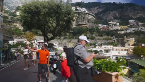 Amalfi-Positano-Italy-Immersive-Travel-Tourism-Mediterranean-Sea-Coast-Water-Europe,-Walking,-4K-|-Blogger,-Couple,-Valley,-Mountainside,-Cliffs,-Looking-Around,-Shaky,-Shop,-Fast,-Traffic,-Crowded