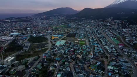 Drone-shot-flying-over-Ushuaia,-Argentina-during-sunset-while-panning-downwards