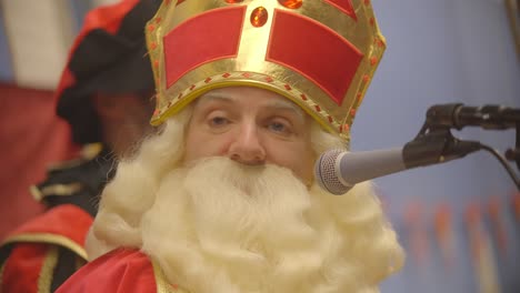 White-middle-aged-male-dressed-as-Sinterklaas-looking-around-close-up-slow-motion