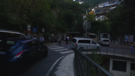 Amalfi-Positano-Italy-Immersive-Travel-Tourism-Mediterranean-Sea-Coast-Water-Europe,-Walking,-4K-|-Couple,-Valley,-Shadows,-Motorcycle,-Mountainside,-Cliffs,-Traffic,-Looking-Around,-Shaky