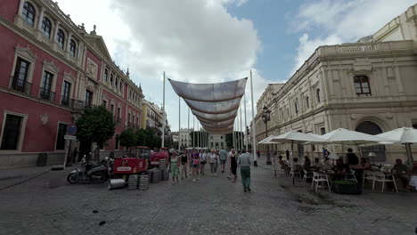 People-Walking-Under-Sun-Shades-Canopy-In-Plaza-de-San-Francisco-In-Seville-Spain