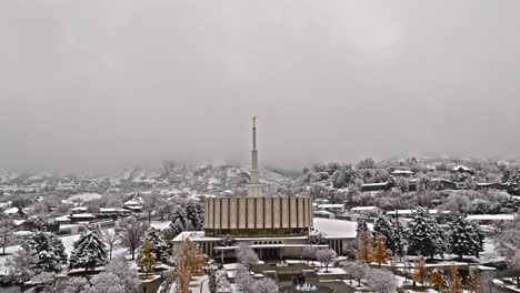 Angled-push-in-dolly-to-Provo-LDS-Mormon-Temple-with-snow-covered-mountains-behind