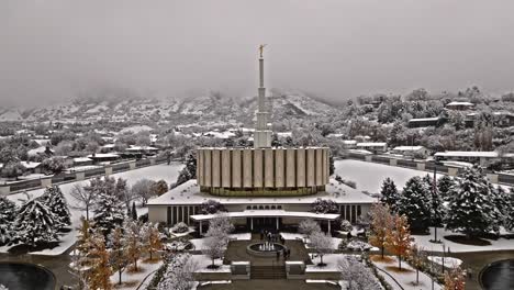 Aerial-dolly-approaches-snow-covered-Provo-LDS-Mormon-Temple-on-cloudy-day