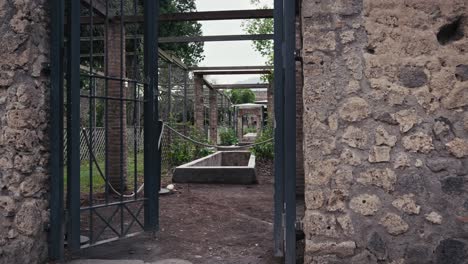 Ancient-gate-to-Quartione's-abode,-Pompeii,-Naples,-Italy