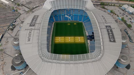 Drone-tilt-down-view-over-Etihad-Stadium-Manchester-City-Football-Club,-UK