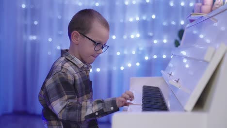 Little-Boy-concentrates-to-play-Piano-for-Christmas