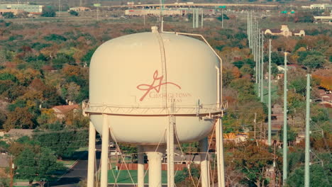 Georgetown,-Texas-landmark-water-tower-drone-aerial-orbit-telephoto-in-suburban-neighborhood-in-fall